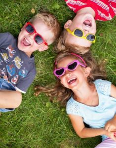 happy kids lying in grass