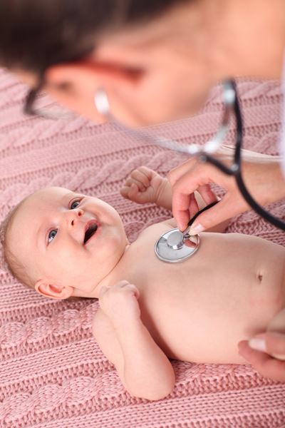 happy baby at a well-child visit