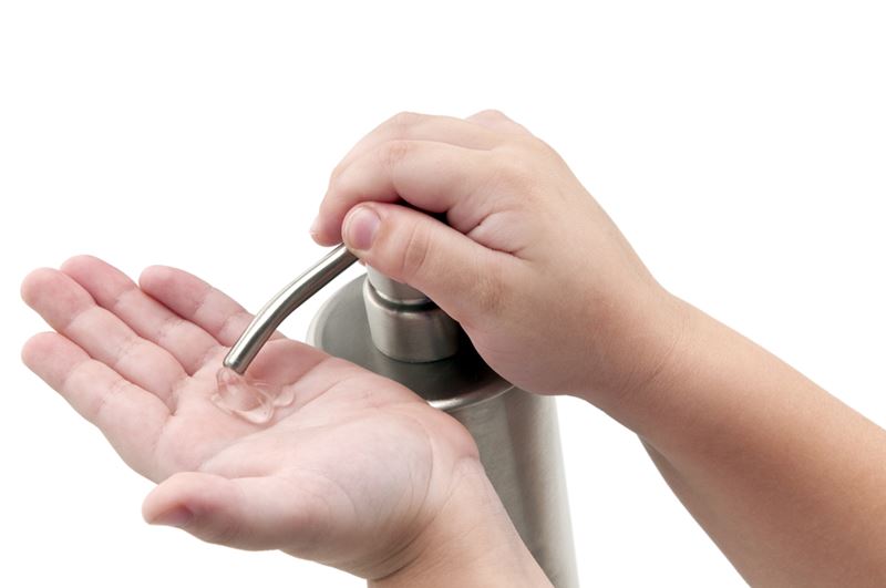 a child using hand sanitizer