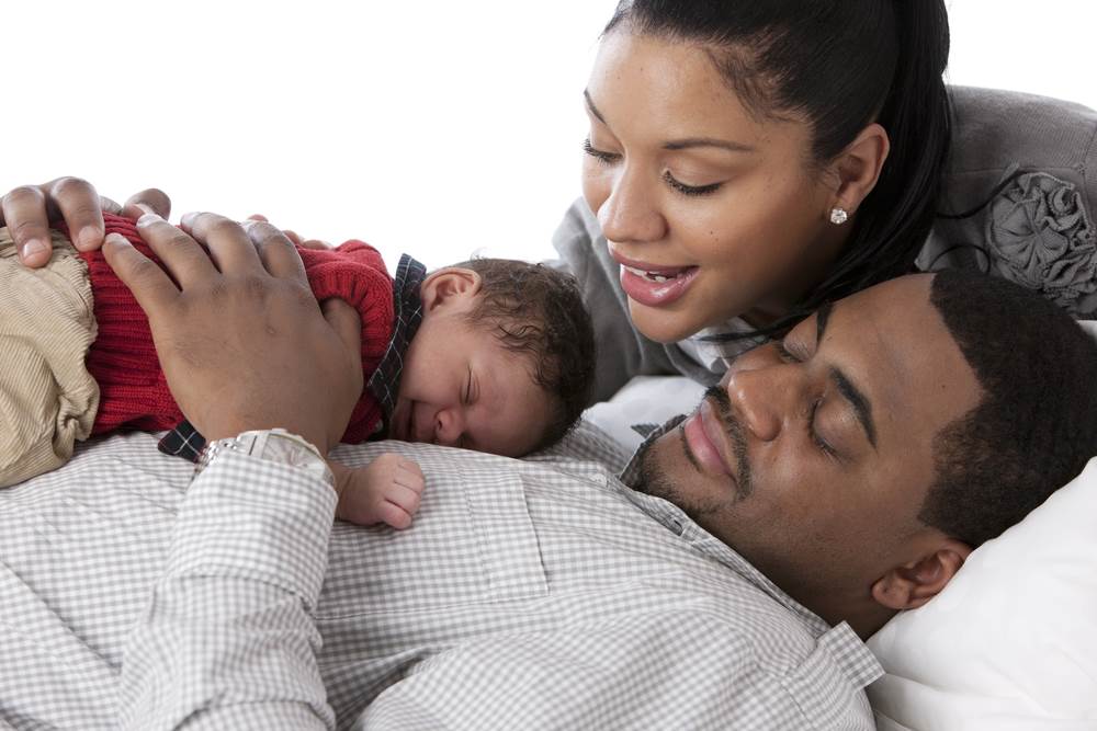 African American family  holding their newborn