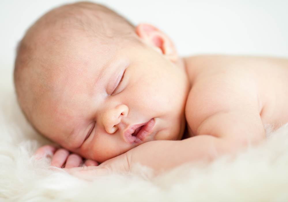 adorable baby sleeping on stomach