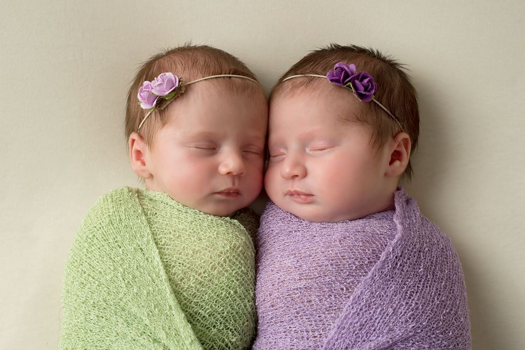 swaddled babies in green and lavender