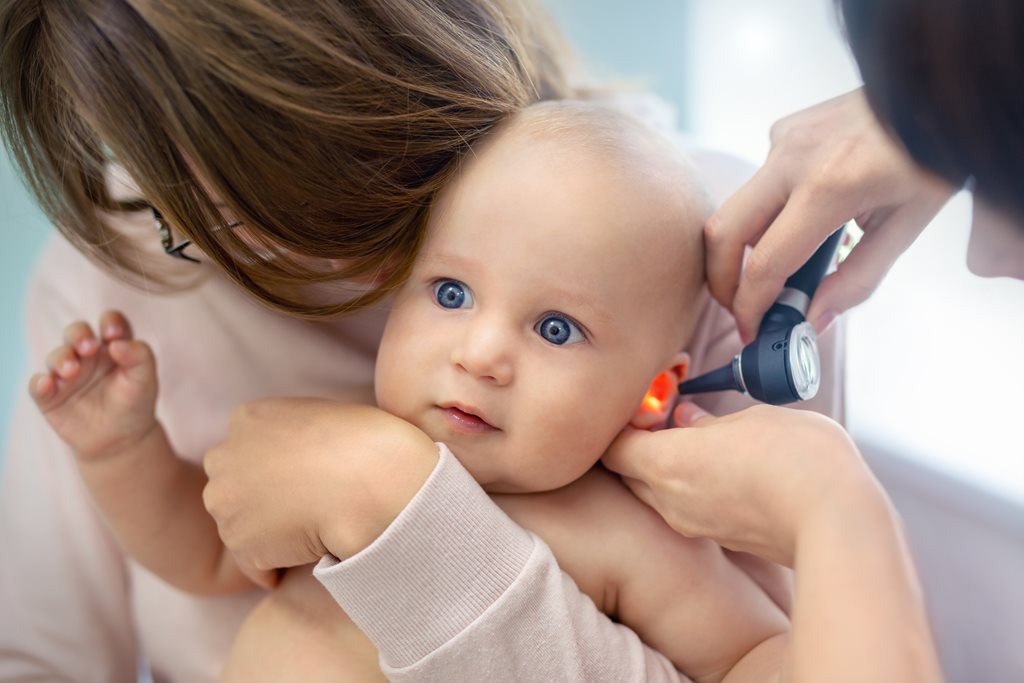pediatrician checking a baby's ear